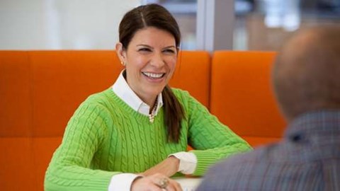 female employee office laughing in a meeting