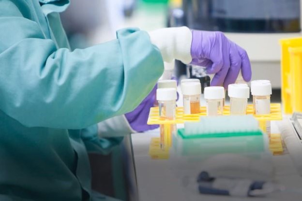 Scientist handling test tubes in a lab