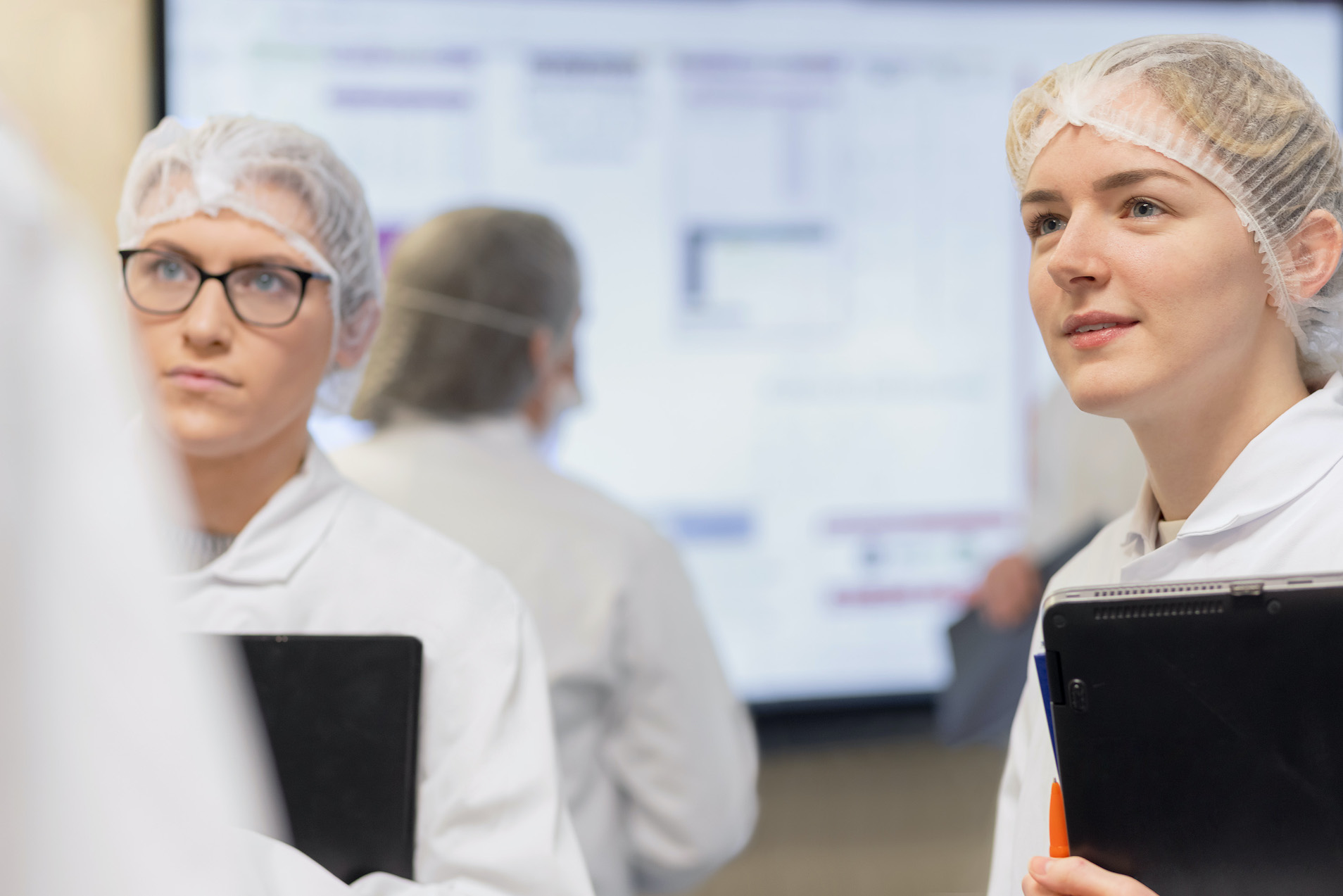 Women in hairnets in a conversation