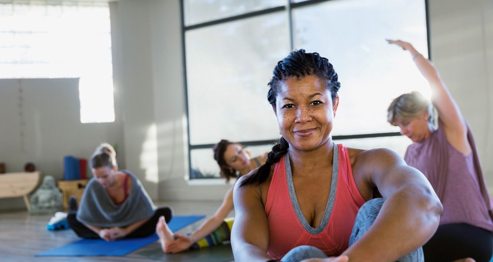 Woman at a yoga class smiling at the camera