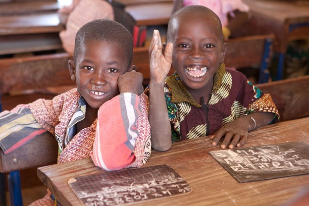 Two children smiling at the camera