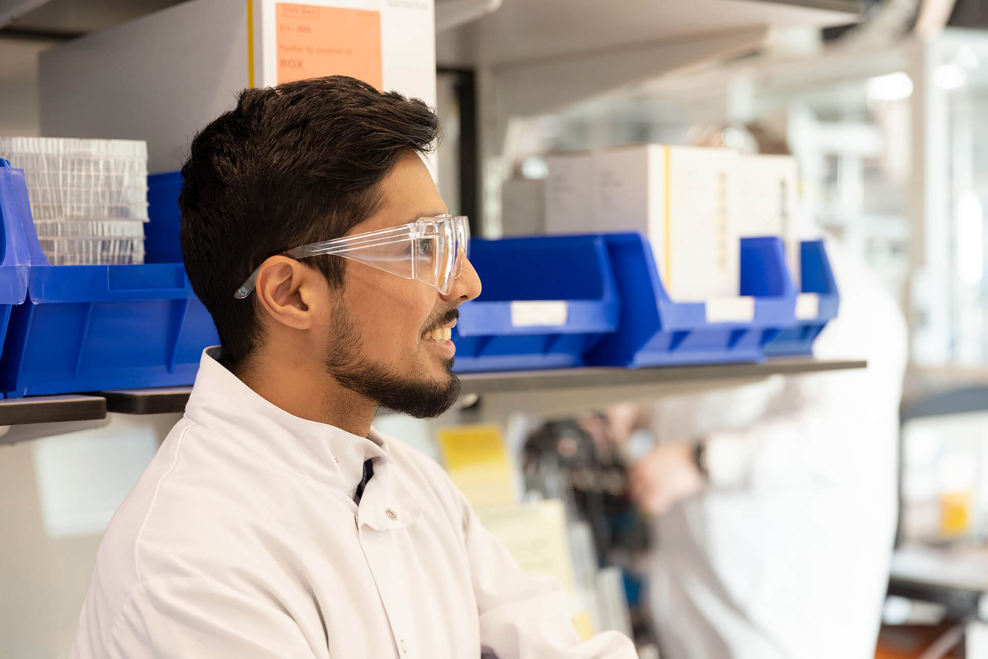 Man in a labcoat looking off camera