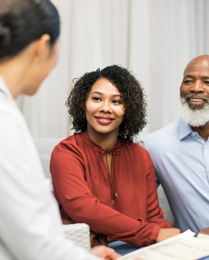 Two people listening to a doctor