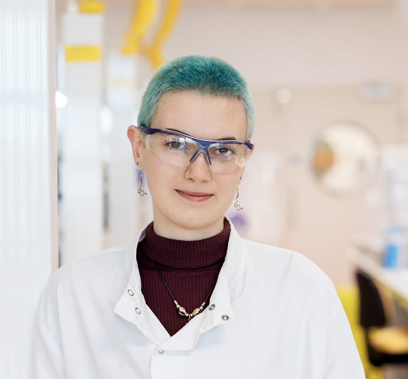 Woman with blue hair smiling at the camera