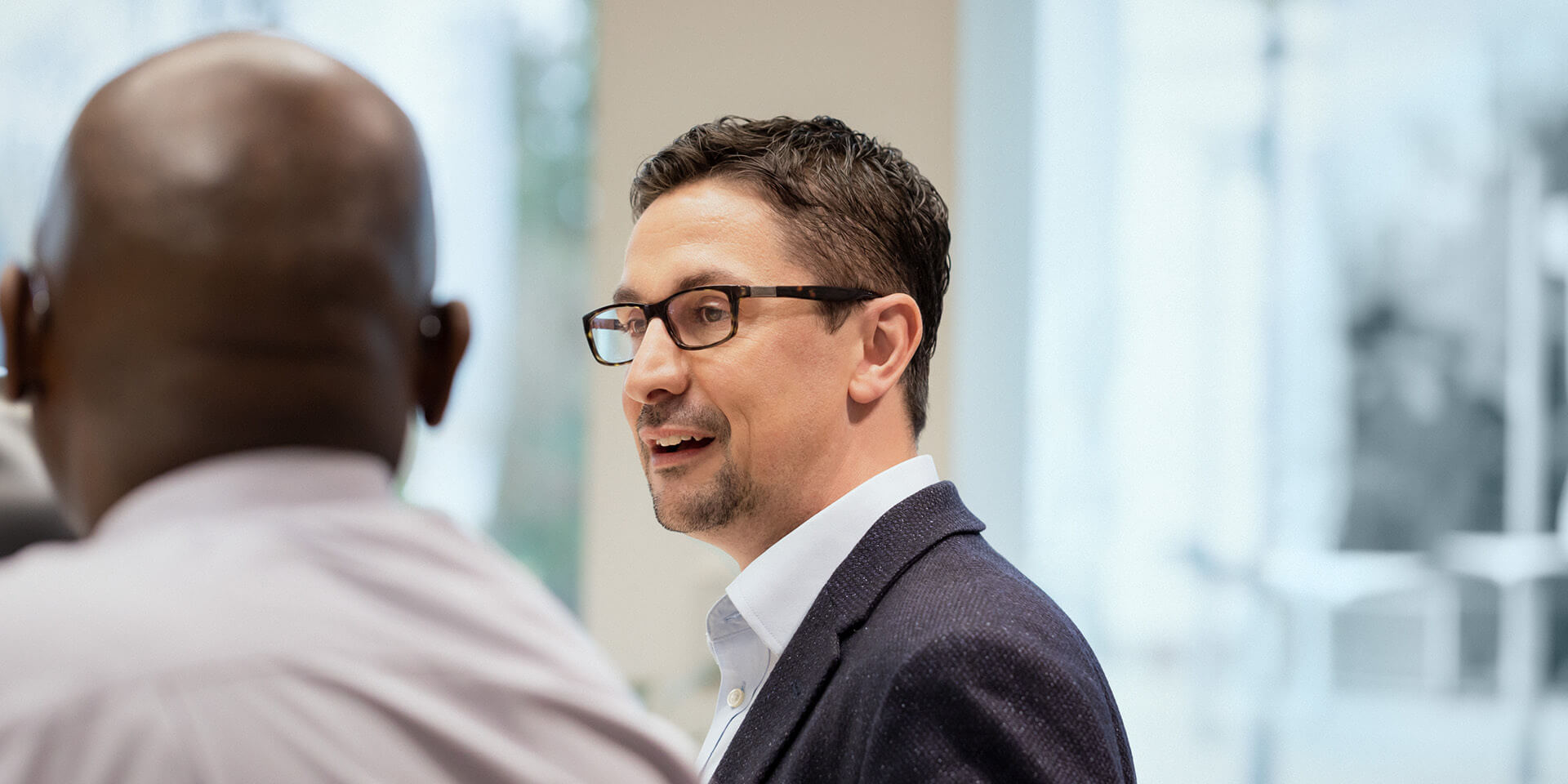 Two people conversing together in an office