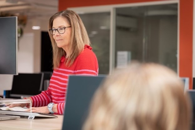 Woman working at a standing at a desk