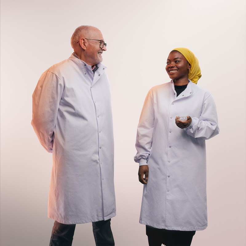 Two scientists in white coats talking together
