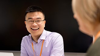 Man smiling during a meeting