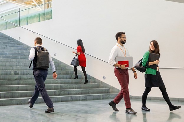 People walking and talking together in an office.