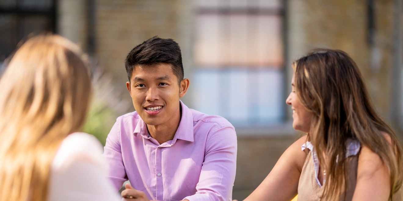 Group of people sitting together around a table