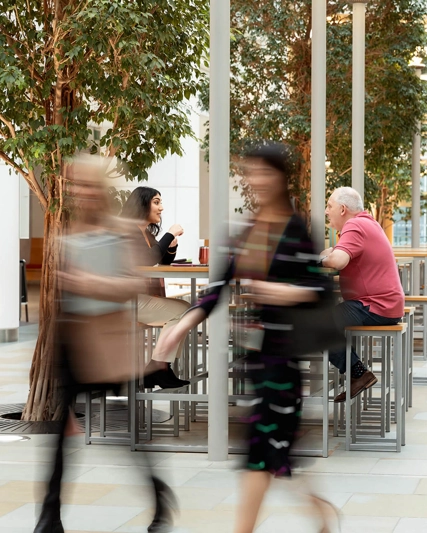 Two blurred figure in a large room.