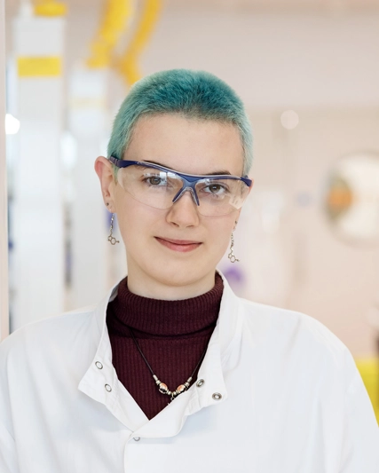 Woman with blue hair smiling at the camera